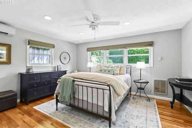 819 SE 98th Ave, Vancouver, WA 98664 - bedroom with light wood finished floors, recessed lighting, a wall unit AC, a ceiling fan, and heating unit