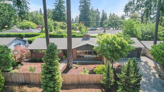 819 SE 98th Ave, Vancouver, WA 98664 - view of front of home featuring a fenced front yard, a garage, brick siding, and roof with shingles
