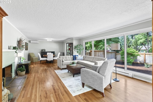 819 SE 98th Ave, Vancouver, WA 98664 - living area featuring a fireplace with raised hearth, a wall mounted air conditioner, a baseboard radiator, ornamental molding, and a textured ceiling