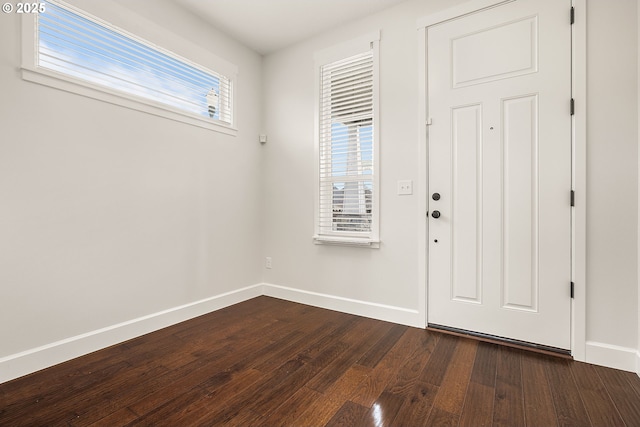 entrance foyer featuring dark wood-type flooring and baseboards