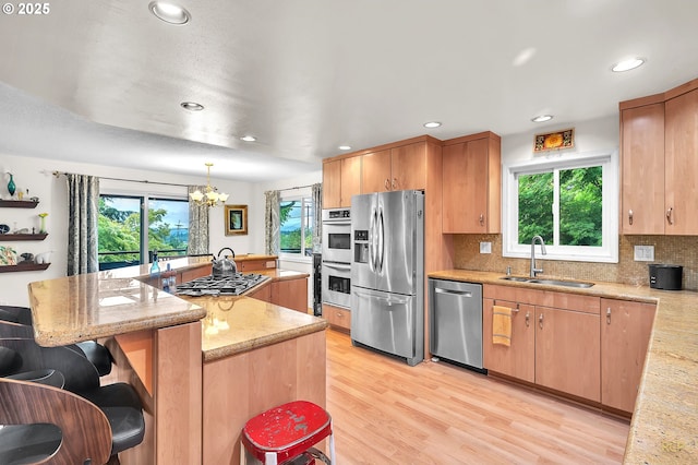 10795 SE 93rd Ct, Happy Valley, OR 97086 - kitchen featuring appliances with stainless steel finishes, a sink, healthy amount of natural light, a chandelier, and recessed lighting