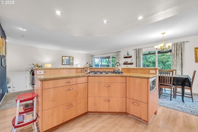 10795 SE 93rd Ct, Happy Valley, OR 97086 - kitchen featuring light wood-style floors, a chandelier, light brown cabinetry, appliances with stainless steel finishes, and recessed lighting