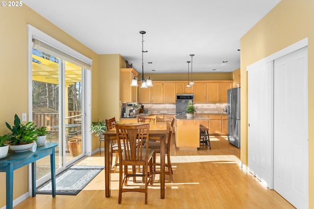 dining area with light hardwood / wood-style flooring