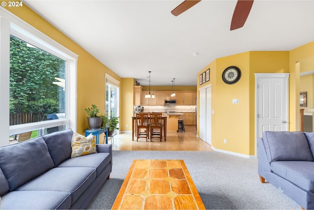 living room featuring light carpet and ceiling fan