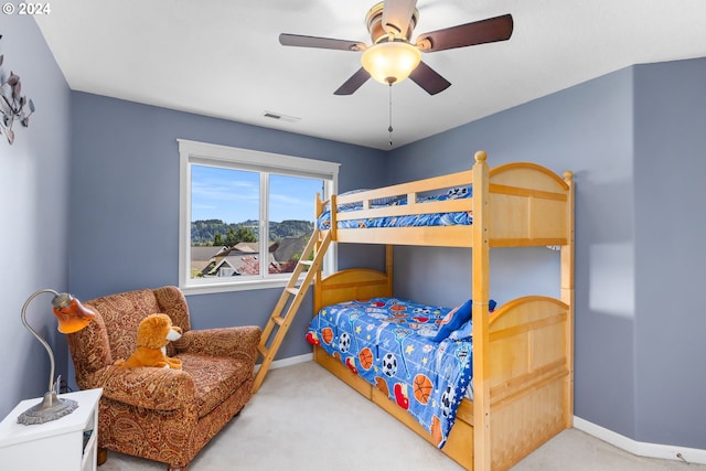 bedroom with ceiling fan and light carpet