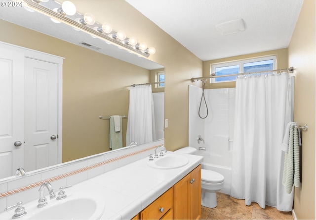 full bathroom featuring vanity, shower / tub combo with curtain, and toilet