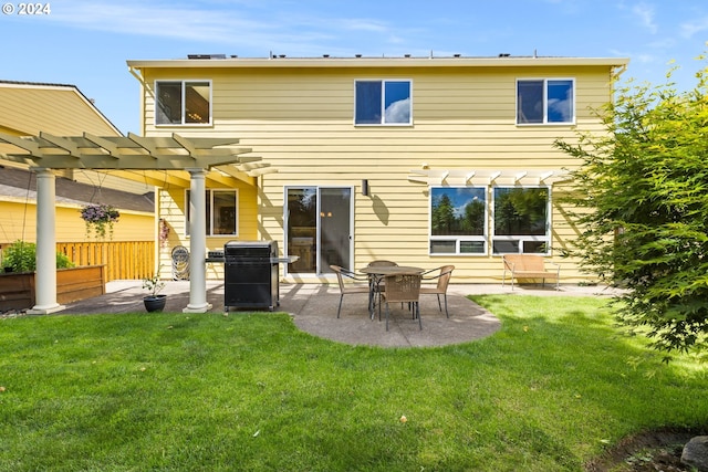 back of house with a yard, a pergola, and a patio area