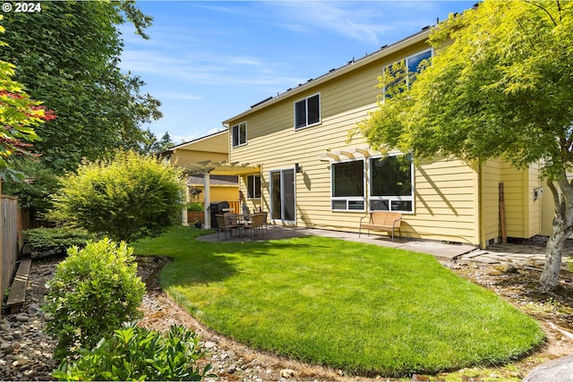 back of house featuring a yard, a pergola, and a patio