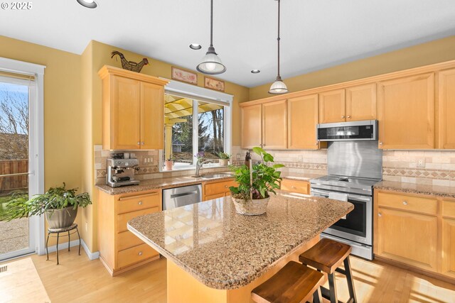 dining area featuring ceiling fan with notable chandelier, a wealth of natural light, and light wood-type flooring