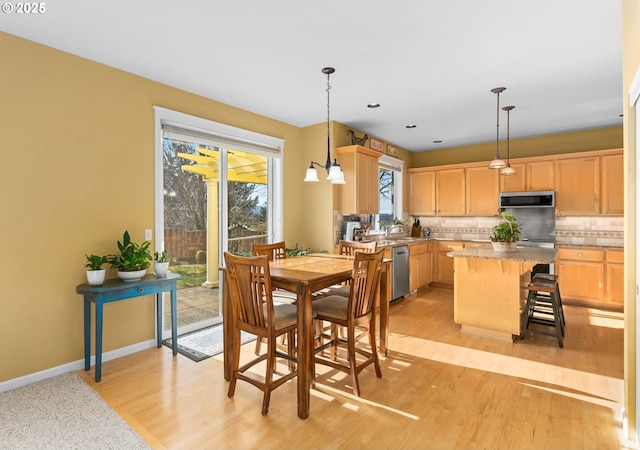 dining area featuring an inviting chandelier and light hardwood / wood-style floors