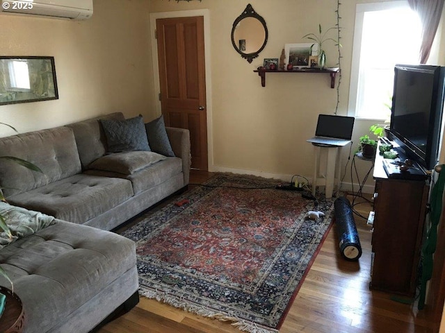 living room with hardwood / wood-style flooring and a wall mounted AC