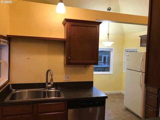 kitchen featuring hanging light fixtures, dishwasher, sink, and white fridge