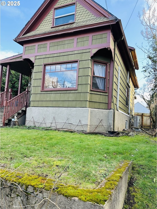 view of side of property with a yard