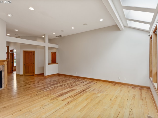 1466 NE 15th Ave, Canby, OR 97013 - unfurnished living room featuring light wood-type flooring, a tile fireplace, recessed lighting, and a skylight