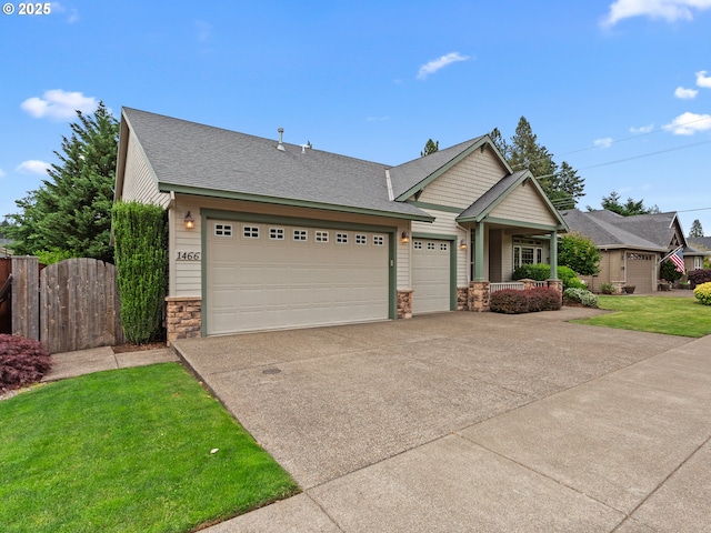 1466 NE 15th Ave, Canby, OR 97013 - view of front facade featuring stone siding, concrete driveway, a garage, covered porch, and a shingled roof