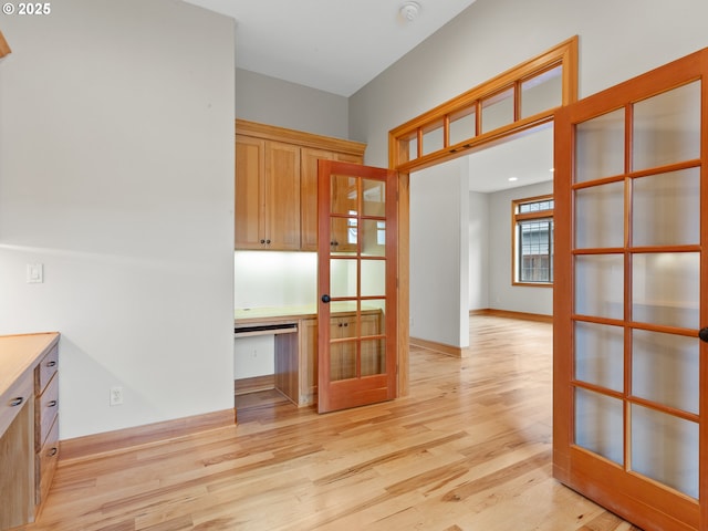 1466 NE 15th Ave, Canby, OR 97013 - kitchen featuring light wood-type flooring, french doors, glass insert cabinets, and light countertops