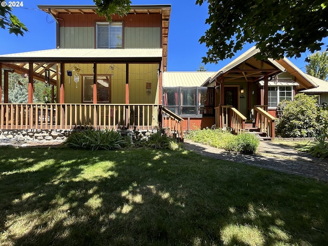 view of front of property with covered porch and a front yard