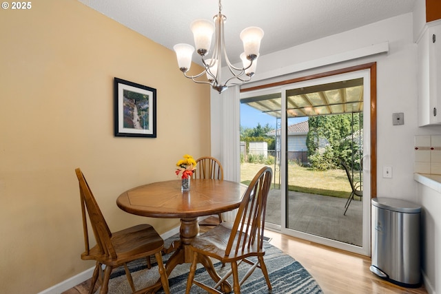 15870 SW Royalty Pkwy, King City, OR 97224 - dining room featuring a chandelier and light wood-type flooring