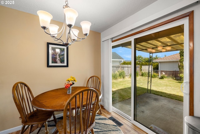 15870 SW Royalty Pkwy, King City, OR 97224 - dining area with light wood finished floors and a chandelier