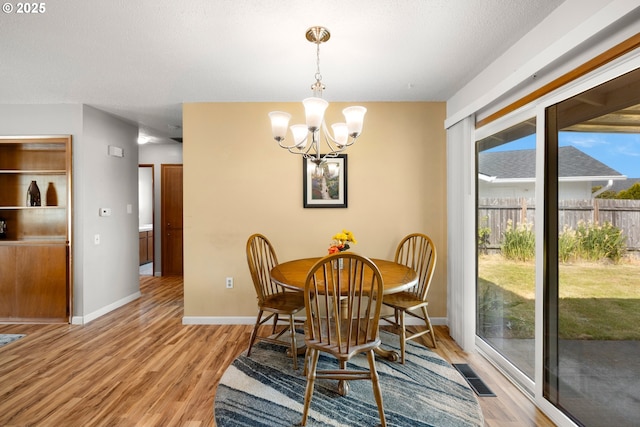 15870 SW Royalty Pkwy, King City, OR 97224 - dining space with a chandelier and light wood-style flooring