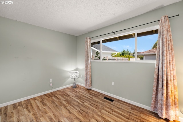 15870 SW Royalty Pkwy, King City, OR 97224 - unfurnished room featuring wood finished floors and a textured ceiling