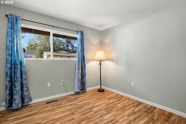 15870 SW Royalty Pkwy, King City, OR 97224 - empty room featuring wood finished floors and a textured ceiling