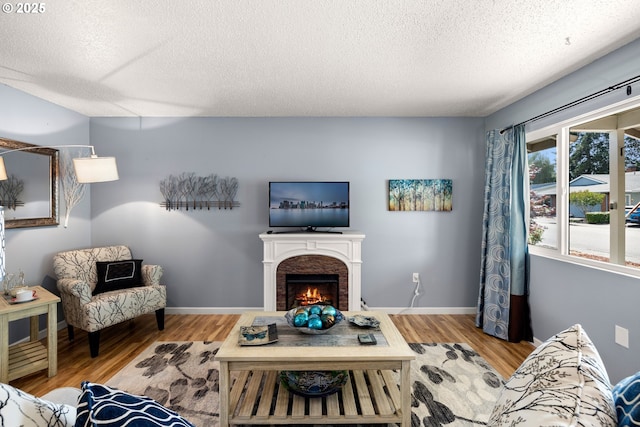 15870 SW Royalty Pkwy, King City, OR 97224 - living area featuring a textured ceiling, wood finished floors, and a brick fireplace