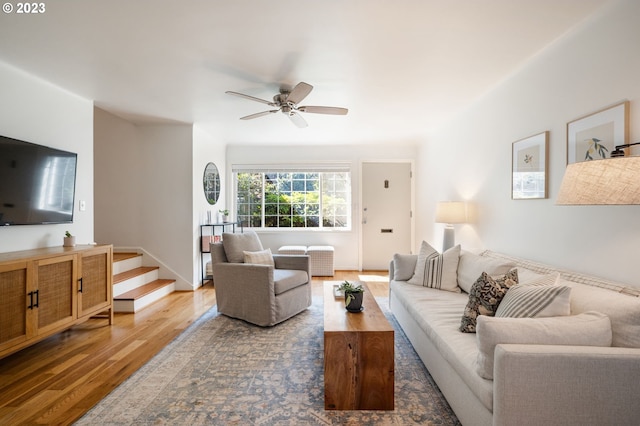 living room with wood-type flooring and ceiling fan