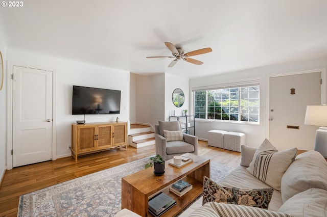 living room with ceiling fan and light hardwood / wood-style floors