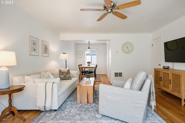 living room with ceiling fan and light wood-type flooring