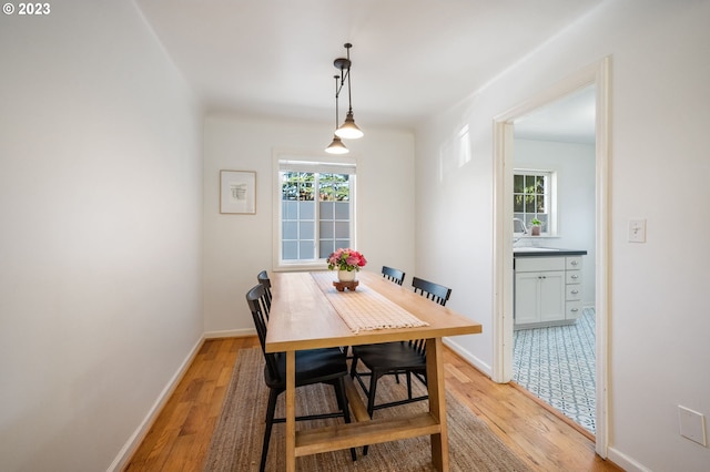 dining room featuring sink and light wood-type flooring