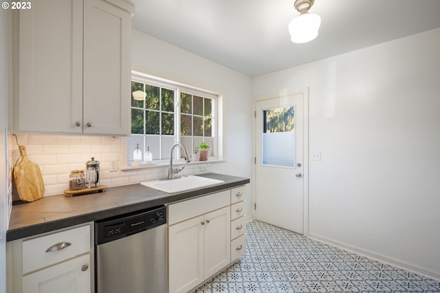 kitchen featuring dishwasher, sink, decorative backsplash, and white cabinets