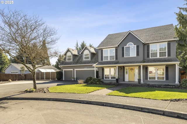 view of front of property featuring driveway, a shingled roof, a front yard, and fence