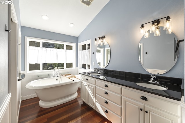 16405 NE 38th St, Vancouver, WA 98682 - bathroom featuring vaulted ceiling, double vanity, wood finished floors, and a freestanding bath