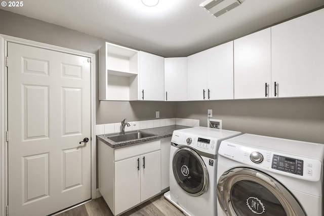 16405 NE 38th St, Vancouver, WA 98682 - laundry room with independent washer and dryer, cabinet space, and light wood-style flooring