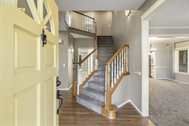 entryway featuring ornamental molding, wood finished floors, and baseboards