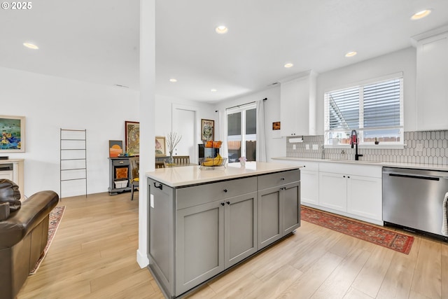 kitchen featuring dishwasher, gray cabinetry, light wood finished floors, tasteful backsplash, and recessed lighting