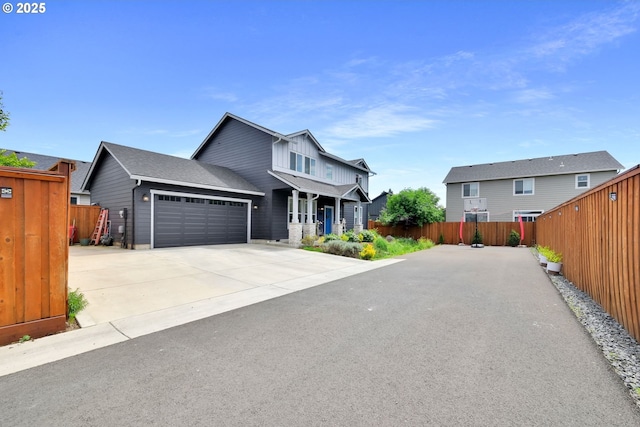 view of front of house with fence, a garage, covered porch, driveway, and a residential view