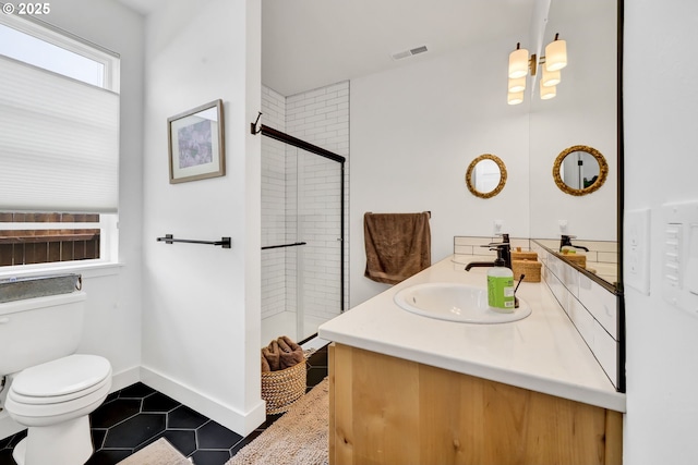 bathroom with tile patterned flooring, a shower stall, toilet, and double vanity