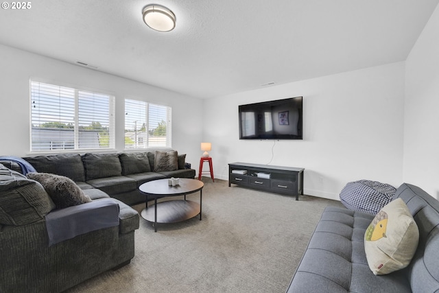 carpeted living room featuring baseboards