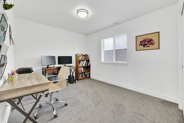 office space featuring carpet floors and baseboards