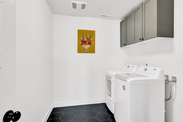 1723 Dotie Dr, Springfield, OR 97477 - washroom featuring cabinet space, washing machine and dryer, dark tile patterned flooring, and baseboards