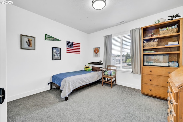carpeted bedroom featuring baseboards