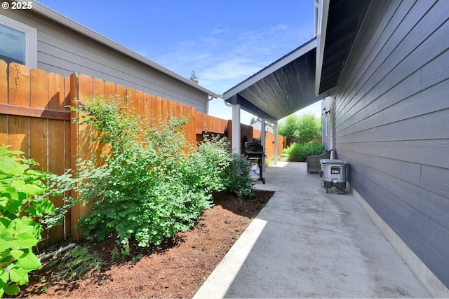 view of side of property with a fenced backyard and a patio