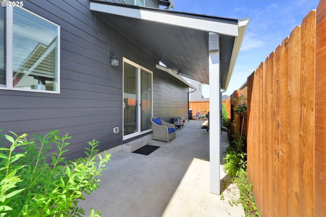 view of side of property featuring a fenced backyard and a patio area