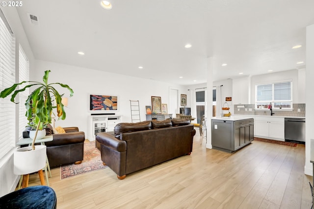 living room with light wood-style floors and recessed lighting