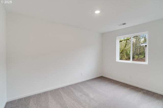 carpeted spare room with recessed lighting, visible vents, and baseboards