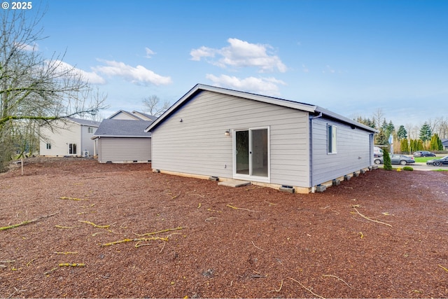 rear view of property featuring crawl space