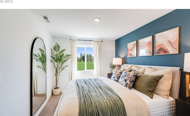 carpeted bedroom featuring visible vents