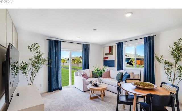 living area with light carpet and plenty of natural light